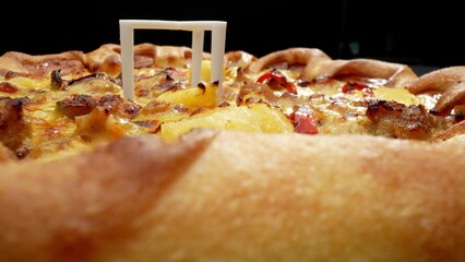 Super close-up captures the irresistible allure of a cheese and sausage pizza slice. Food and Diet...