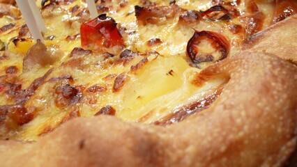 Witness the delicious details of a cheesy, sausage-topped pizza in stunning macro close-up. Dining...