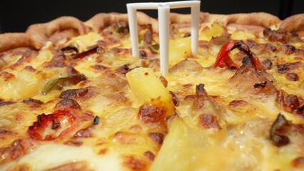 Tempting close-up: Dive into a cheesy, sausage-packed pizza slice, a mouthwatering spectacle....