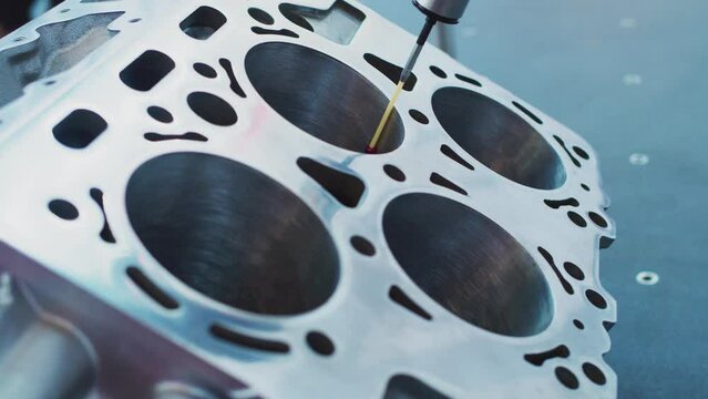 Modern industrial technologies. Metalworking. Coordinate Measuring Machine Using a Ruby Red Torch Probe to Measure Tolerances of Parts in a Manufacturing Facility.