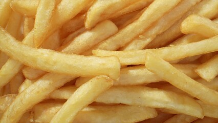 French fries are thin strips of potatoes that are deep-fried until crispy and golden brown. They are a popular snack enjoyed worldwide for their crunchy exterior and soft interior. Food concept. 
