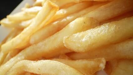 Crispy, golden potato sticks fried to perfection, French fries are a beloved snack or side dish, loved for their crunchy exterior and fluffy interior. Food concept. French fries background. 
