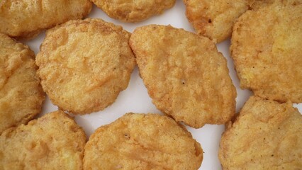 A chicken nugget is a small piece of chicken, breaded or battered, then deep-fried or baked. Popular as a fast food snack or a kid's menu item. Food concept. Fast-food background. 
