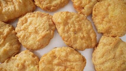 Chicken nuggets are beloved, bite-sized chicken pieces, breaded and cooked by frying or baking. Made from processed chicken meat, they come in assorted shapes and are coated with seasoned breading.
