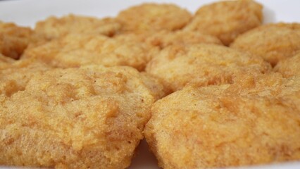 Chicken nuggets are bite-sized pieces of chicken meat that are typically breaded and fried until golden brown. They are a popular fast food item and can be enjoyed as a snack or a meal. Food concept.
