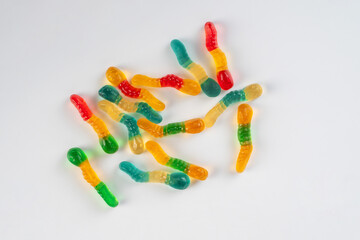 Fruit flavored worm shape, jelly candies. Isolated on white background.