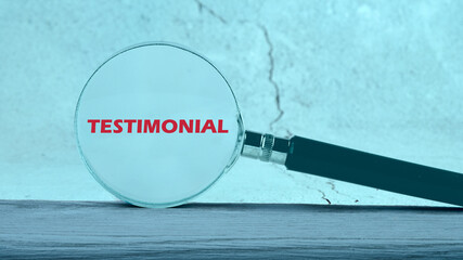 The word Testimonial through a magnifying glass on an abstract background