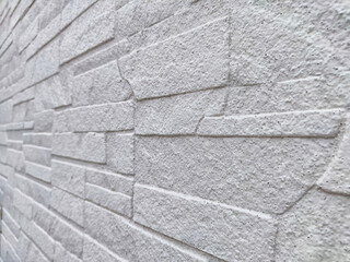 Uneven stones or bricks as a background and texture. Background, texture, pattern, frame, copy space. Close-up view of a wall with uneven stone bricks