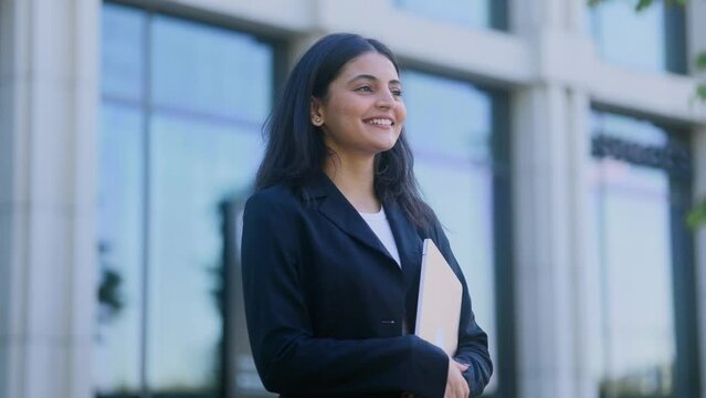 Portrait of carefree young indian woman feeling absolutely happy and satisfied enjoying great day outdoors Self confidence female looking ahead feel proud achievement alone