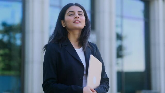 Portrait of carefree young indian woman feeling absolutely happy and satisfied enjoying great day outdoors Self confidence female looking ahead feel proud achievement alone