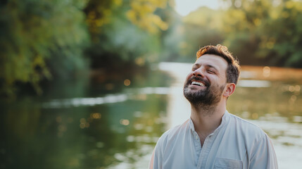 Obraz premium A man in a light shirt stands in front of a serene river landscape, exuding a sense of calm and reflection