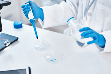 Sample, test and hands in lab, particles and scientist with gloves, working and chemical for...
