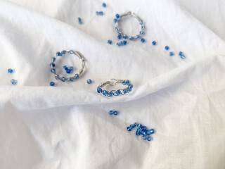 Handmade wire copper rings with blue beads. Wire wrapped accessories, white background.