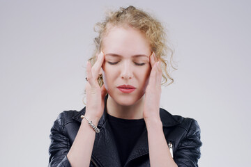 Woman, headache and pain in studio with stress pressure for vertigo fatigue, migraine or burnout....