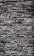 The walls are decorated with tiles made from natural gray sandstone. a vertical image