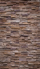 The walls are decorated with tiles made from natural red-brown sandstone. a vertical image