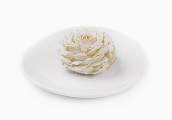 White floral cake decoration on plate