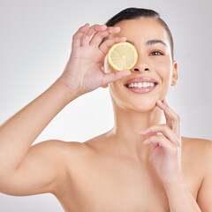 Studio, lemon and face of woman, smile and brightening of skin, beauty and wellness with facial....