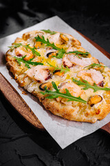 Gourmet shrimp pizza with fresh arugula