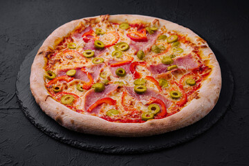 Delicious italian pepperoni pizza with olives on slate