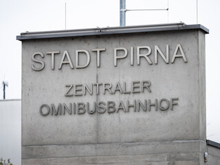 Obraz premium Zentraler Omnibusbahnhof in Pirna (central bus station) sign on the building of the public transport facility in the town. Mobility in Eastern Saxony.