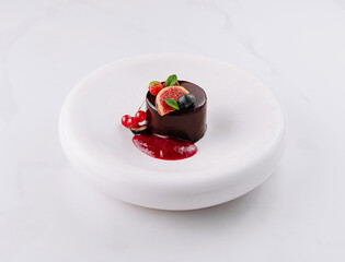 Elegant chocolate dessert with berry sauce