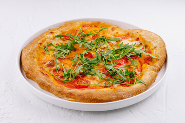 Fresh italian pizza with arugula and tomato