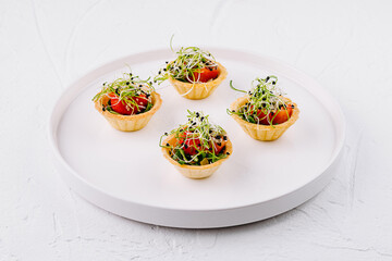 Gourmet tartlets with fresh tomatoes and sprouts