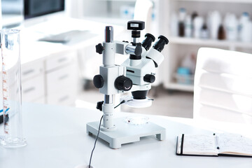 Microscope, lab and science on table for research or development, chemistry or investigation for...