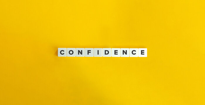 Confidence Word and Banner. Concept of developing  a sense of self-assurance and belief in one's own abilities, qualities, and judgment. Text on Block Letter Tiles on Yellow Background.