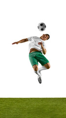 Dynamic shot of soccer player jumps in mid-air prepares to head soccer ball, with his body twisted...