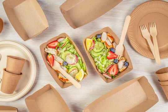 salad with chicken and vegetables served in recyclable containers. Eco friendly disposable dishes