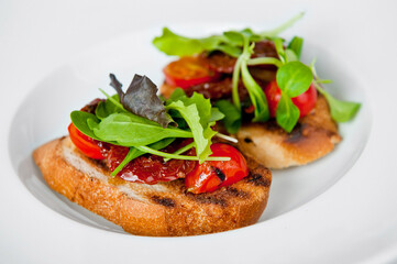 Gourmet toast with fresh tomatoes and greens