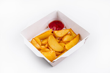 Crispy potato wedges in takeout box with ketchup