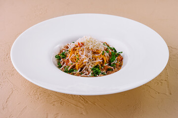 Gourmet spaghetti bolognese with parmesan on white plate
