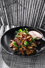 Gourmet fried mushrooms with beef steak and dip on elegant plate