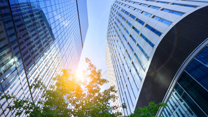 Sustainable glass office building with trees for reducing carbon dioxide. Eco-friendly building in modern city. Office with green environment. Corporate building reduce CO2.