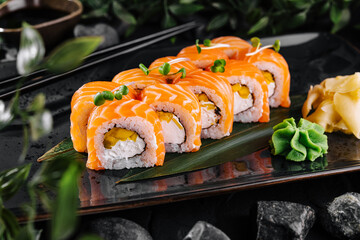 Salmon sushi roll platter on elegant dark background