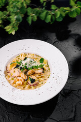 Gourmet pasta dish with shrimp, mussels on elegant plate