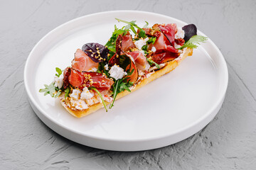 Gourmet bruschetta with prosciutto and feta cheese