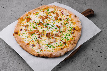 Freshly baked gourmet pizza on wooden board