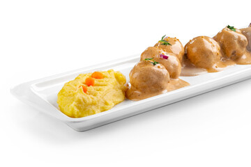 Meat meatballs with mustard sauce and sesame seeds in a white plate isolated on a white background, close up