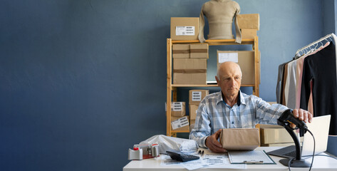 The owner of an online clothing store scans the barcode of cardboard order boxes. Small business