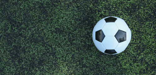 Soccer ball on fresh green grass outdoors