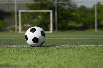 Soccer ball on fresh green grass outdoors