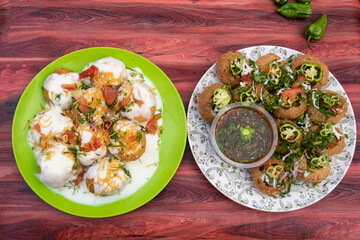 plain or Doi Fuchka, pan puri, or gol gappa filled with herbs with spicy water served in plate isolated on wooden table top view of bangladeshi street food © Food Shop