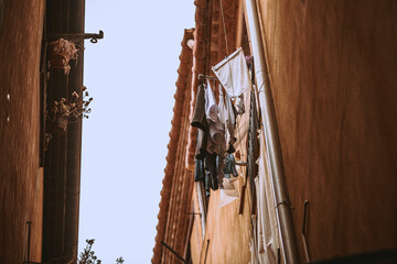 clothes hanging out of a wooden window