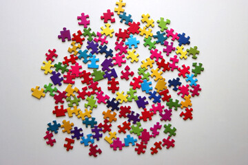 Colorful jigsaw puzzle pieces on white background. Flat lay.