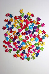 Colorful jigsaw puzzle pieces on white background. Flat lay.