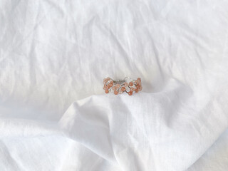 Handmade rings with rose quartz beads on white background.
